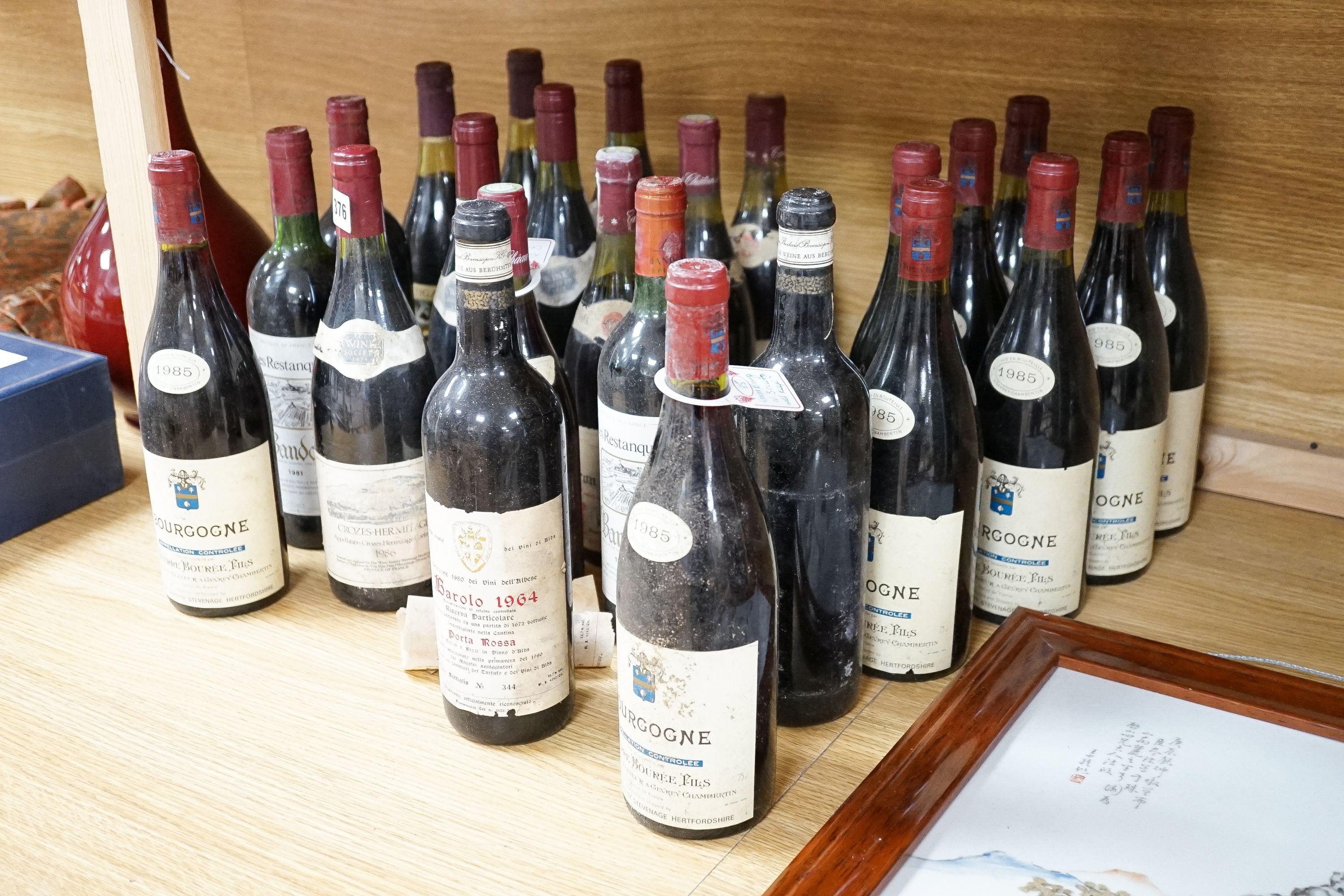 A collection of 24 bottles of red wines including 9 bottles of 1985 Bourgogne, 2 bottles of 1964 Barolo, 4 bottles 1986 Crozes Hermitage